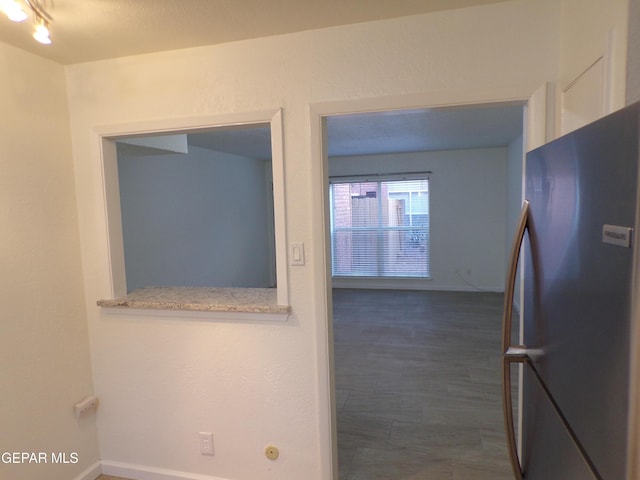 hall featuring baseboards