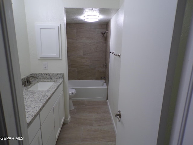 full bathroom featuring toilet, vanity, and shower / tub combination