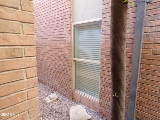 view of side of home featuring brick siding