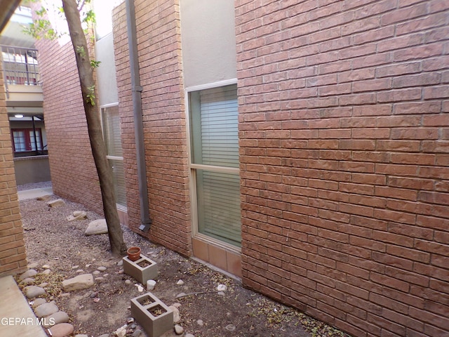 view of property exterior with brick siding