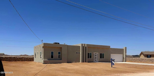 14706 Shape Dr, El Paso, TX 79928 - view of front of house featuring an attached garage, stucco siding, and driveway