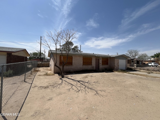 view of front of house featuring fence and brick siding
