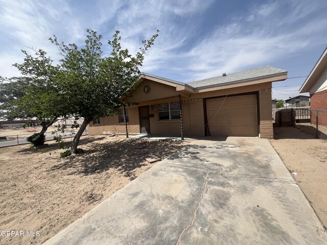 200 Romeria Dr, El Paso, TX 79907 - view of front facade with an attached garage, driveway, brick siding, and fence