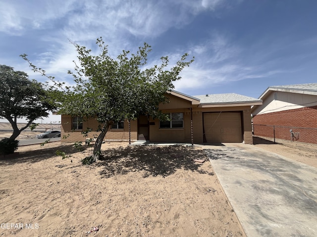 200 Romeria Dr, El Paso, TX 79907 - view of front facade featuring concrete driveway, brick siding, fence, and a garage