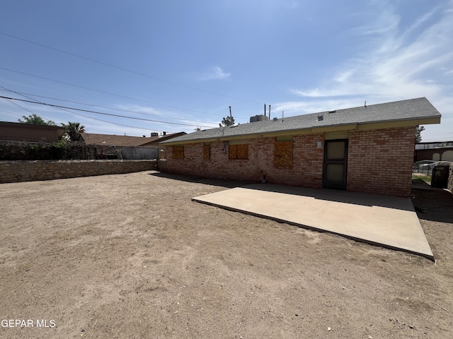 276 Romeria Dr, El Paso, TX 79907 - back of house featuring fence, brick siding, and a patio