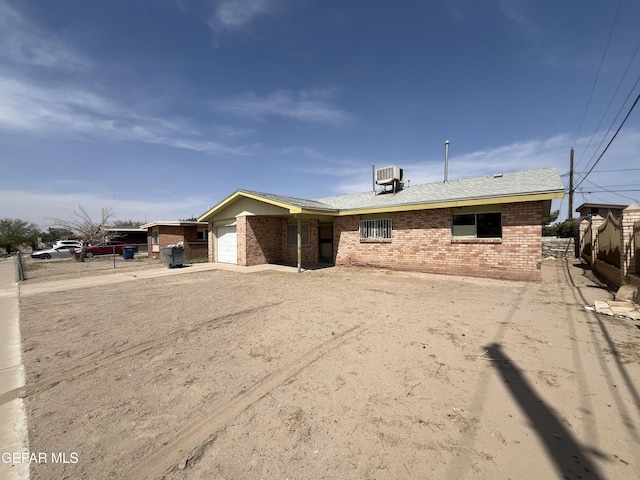 276 Romeria Dr, El Paso, TX 79907 - view of front of home with fence, cooling unit, an attached garage, driveway, and brick siding