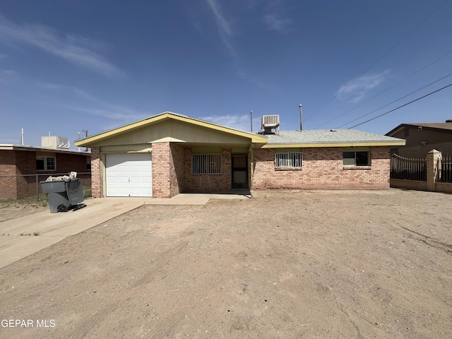 276 Romeria Dr, El Paso, TX 79907 - single story home with fence, central air condition unit, concrete driveway, brick siding, and a garage