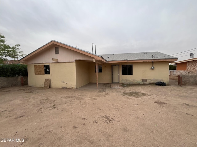 back of property with stucco siding