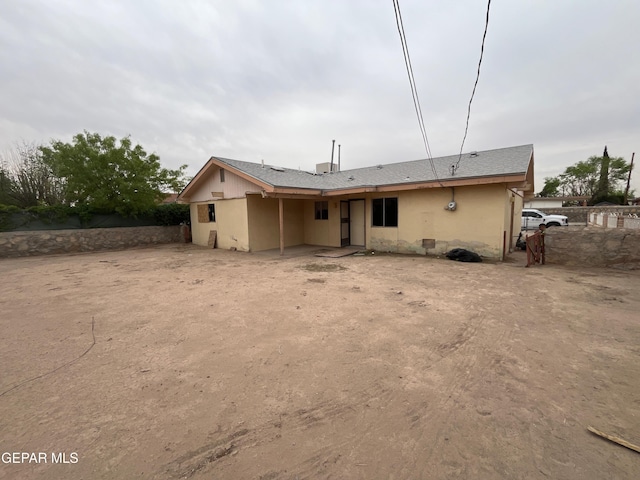 back of property featuring fence