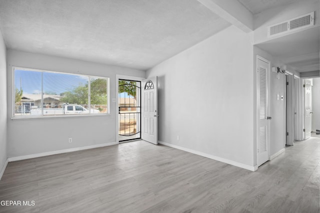 5716 Dearborne Dr, El Paso, TX 79924 - unfurnished room with wood finished floors, baseboards, and a textured ceiling