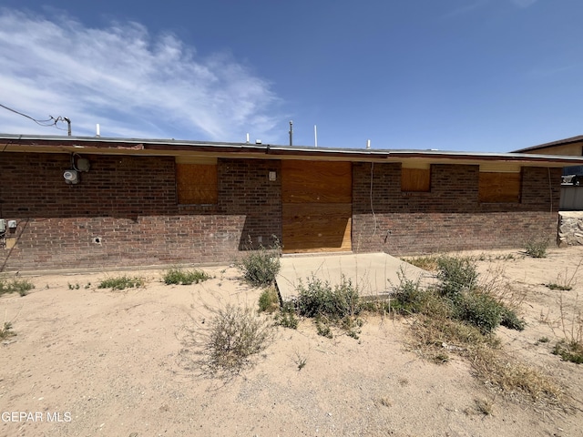 rear view of property featuring brick siding