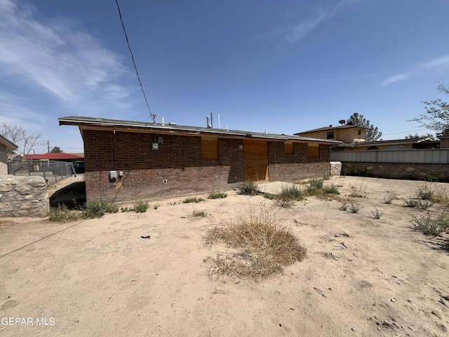 rear view of property with brick siding