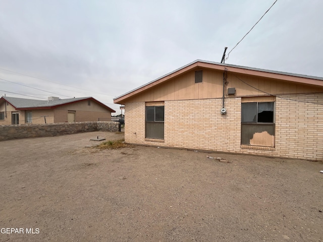view of side of property featuring brick siding