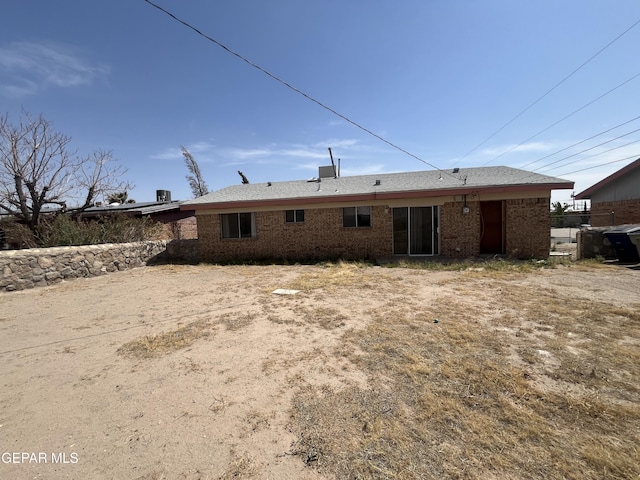 rear view of house featuring brick siding