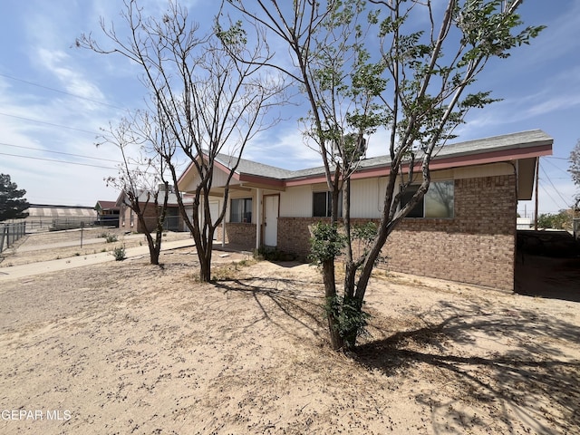 ranch-style house with fence and brick siding