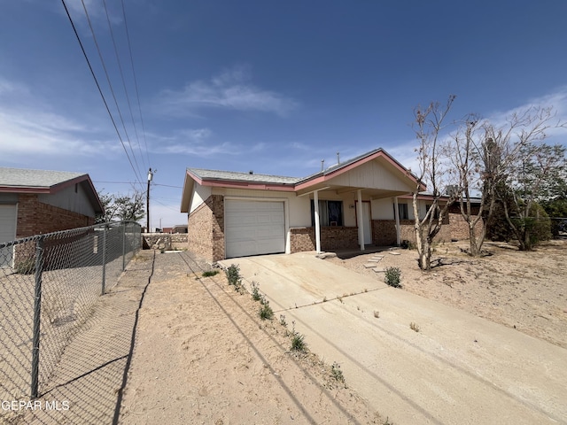 single story home featuring brick siding, an attached garage, driveway, and fence