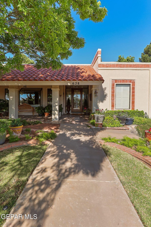 view of front of home with a tiled roof and stucco siding