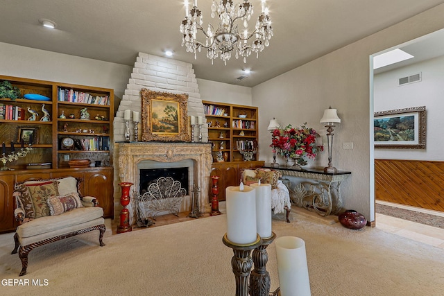 living area featuring visible vents, carpet, a notable chandelier, and a fireplace