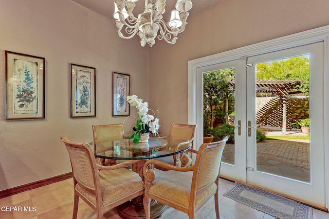 dining room featuring an inviting chandelier, baseboards, french doors, and light tile patterned flooring