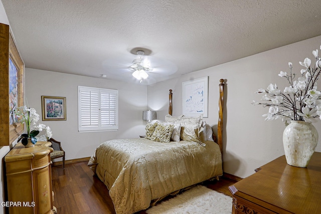 628 Spring Crest Dr, El Paso, TX 79912 - bedroom featuring a textured ceiling, baseboards, and wood finished floors