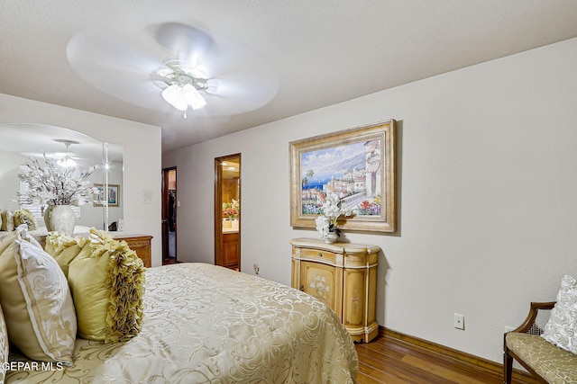 628 Spring Crest Dr, El Paso, TX 79912 - bedroom with ceiling fan, connected bathroom, baseboards, and wood finished floors
