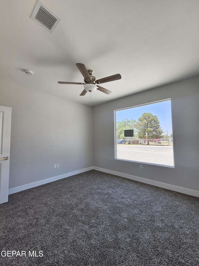 474 Sylvia Ct, Socorro, TX 79927 - spare room with a ceiling fan, dark carpet, and a smoke detector