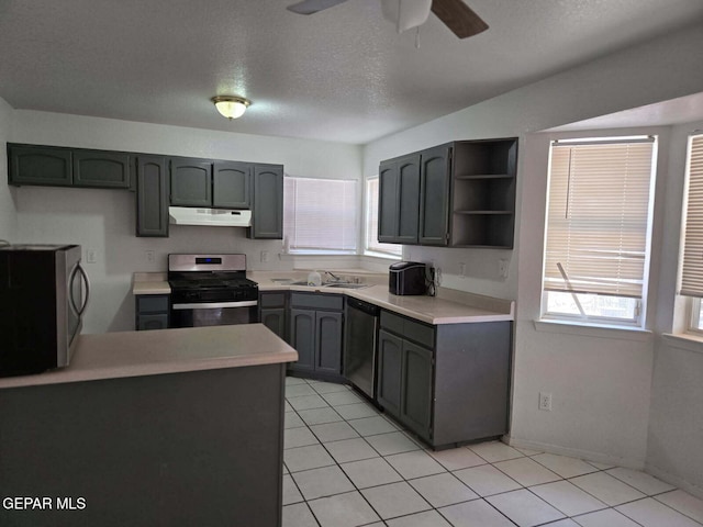 12525 Angie Bombach, El Paso, TX 79936 - kitchen with appliances with stainless steel finishes, under cabinet range hood, a ceiling fan, light countertops, and open shelves
