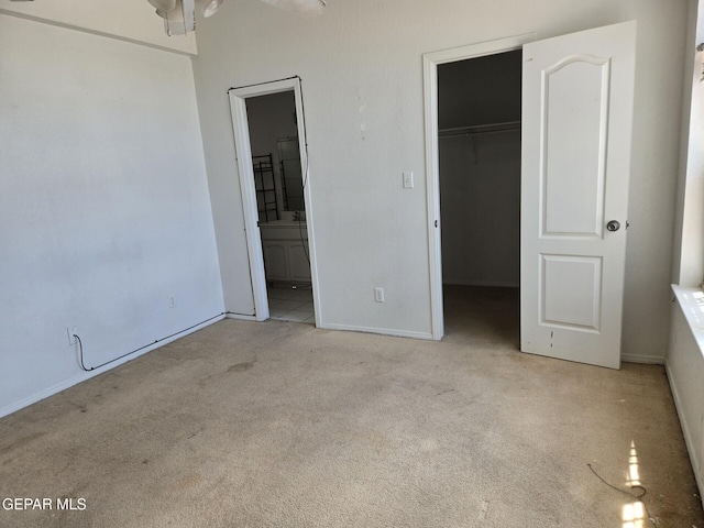 12525 Angie Bombach, El Paso, TX 79936 - unfurnished bedroom featuring carpet flooring, a spacious closet, baseboards, a closet, and ensuite bath