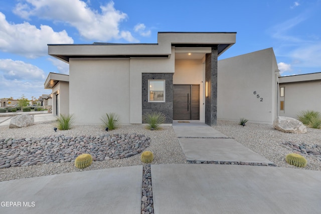 view of front of house with stucco siding and an attached garage