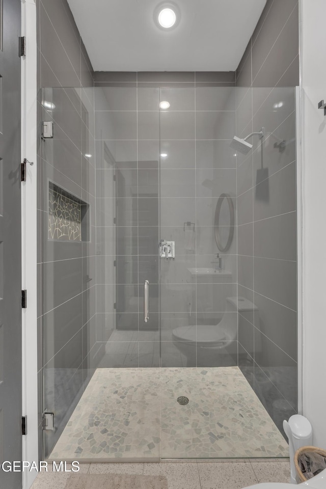 full bathroom with a stall shower and toilet