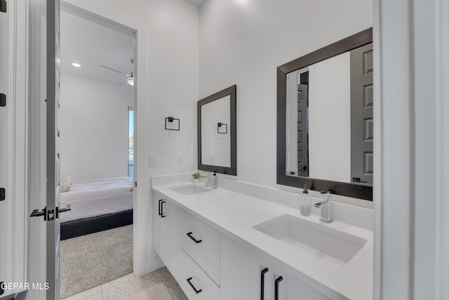ensuite bathroom with a sink, ensuite bathroom, a ceiling fan, and double vanity