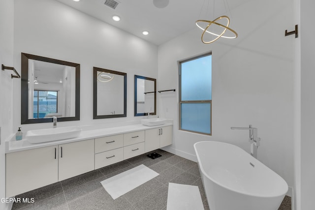 full bathroom featuring a sink, baseboards, granite finish floor, and visible vents