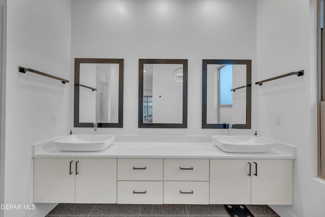 full bath with a sink and double vanity