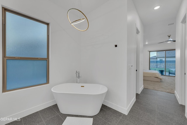 bathroom with granite finish floor, baseboards, ensuite bathroom, a soaking tub, and recessed lighting