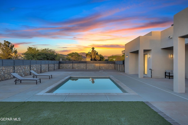 view of swimming pool featuring a patio, fence, and a fenced in pool