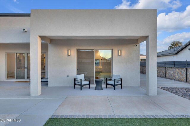 exterior space featuring stucco siding, a patio area, and fence