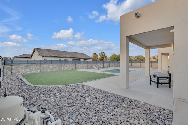 view of yard featuring a patio, a fenced in pool, and a fenced backyard