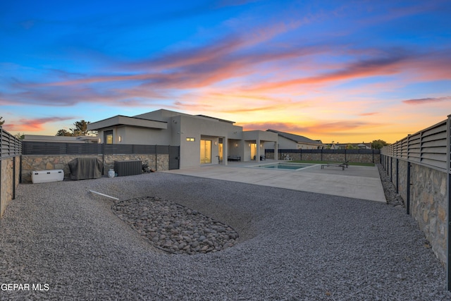exterior space featuring a patio, a fenced backyard, stucco siding, and a fenced in pool
