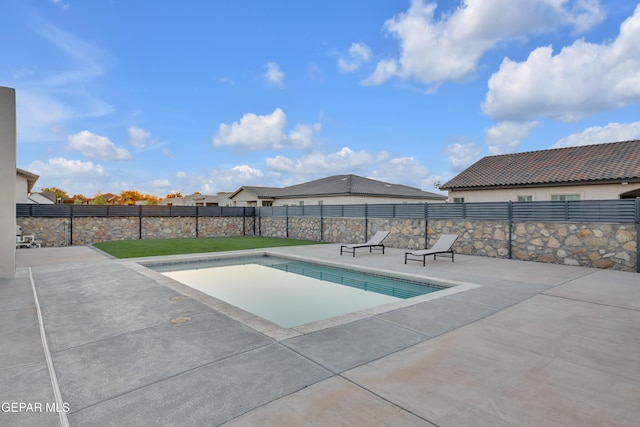 view of swimming pool with a patio, a fenced in pool, and fence