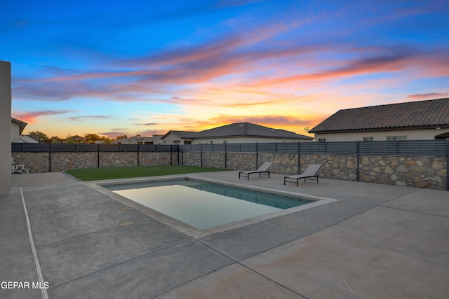 pool at dusk with a fenced in pool, a patio area, and fence