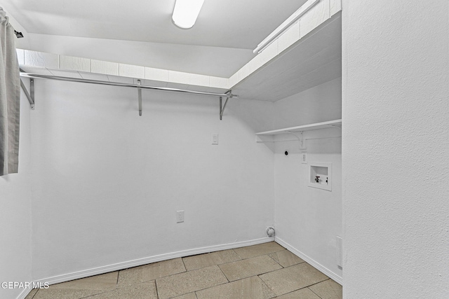 washroom with electric dryer hookup, washer hookup, laundry area, and baseboards