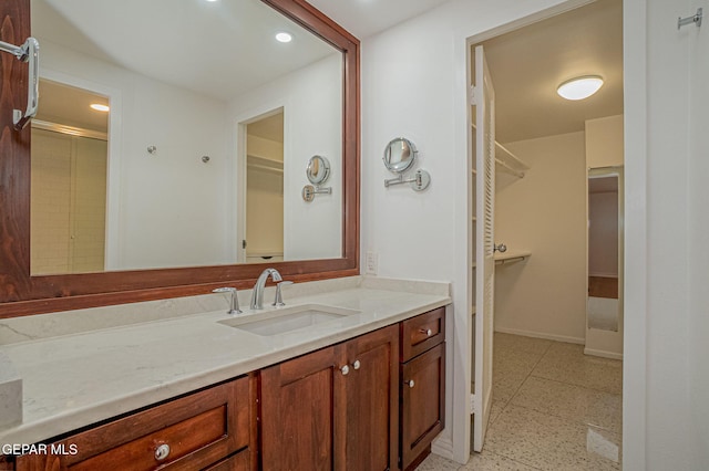 1800 N Stanton Unit 502, El Paso, TX 79902 - full bath with a spacious closet, baseboards, vanity, and recessed lighting