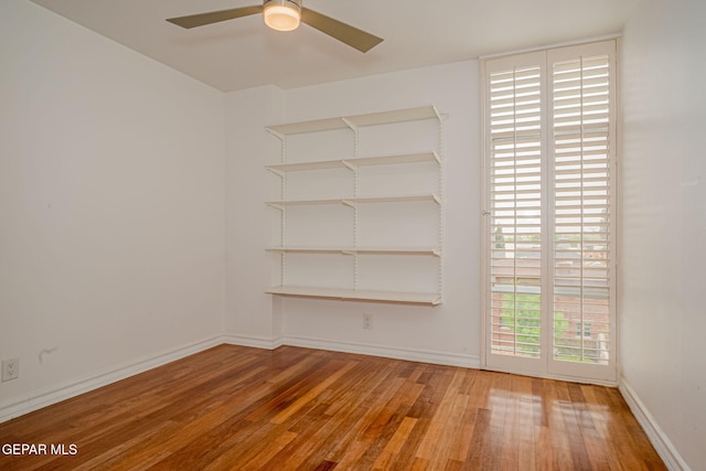 1800 N Stanton Unit 502, El Paso, TX 79902 - empty room with baseboards, a ceiling fan, and hardwood / wood-style flooring