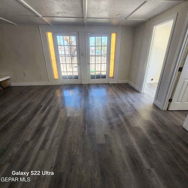 interior space featuring dark wood finished floors and baseboards
