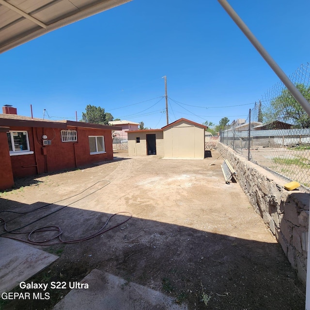 exterior space with an outbuilding and fence