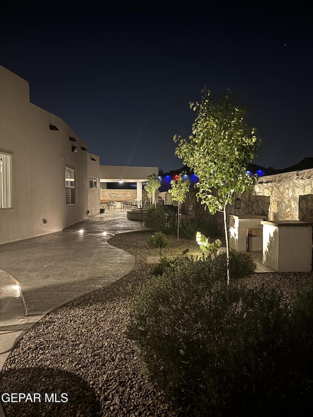 12405 Addingham Ct, El Paso, TX 79928 - yard at twilight featuring a patio and fence