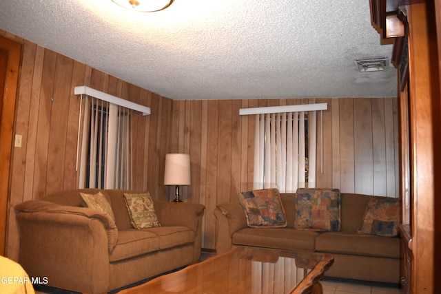 632 Mauer Rd, El Paso, TX 79915 - living room featuring wooden walls and a textured ceiling