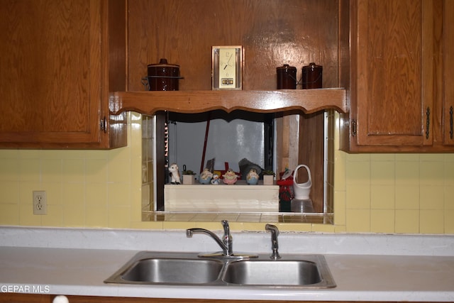 632 Mauer Rd, El Paso, TX 79915 - kitchen with backsplash, light countertops, and brown cabinetry