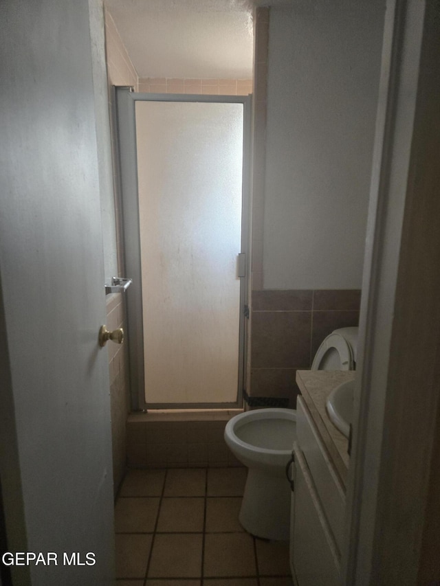 632 Mauer Rd, El Paso, TX 79915 - bathroom with vanity, a stall shower, tile patterned flooring, and tile walls