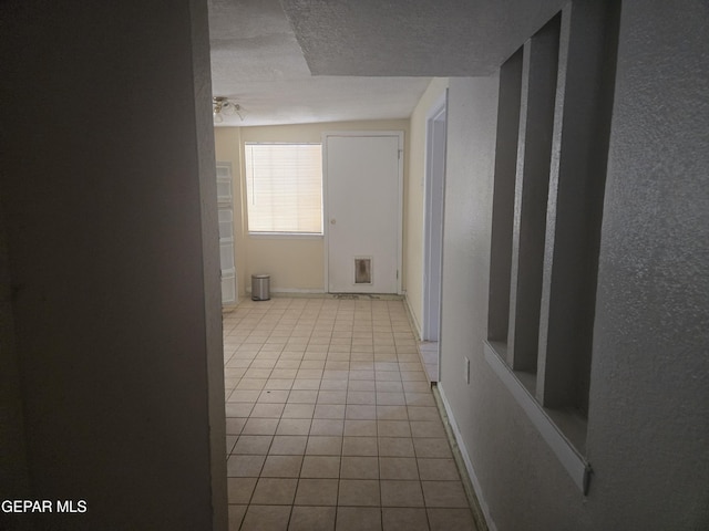 632 Mauer Rd, El Paso, TX 79915 - corridor with tile patterned floors and a textured ceiling